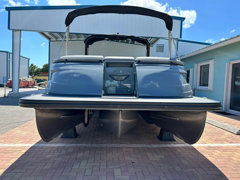 Slide: The Image of 2024 Bennington 28 QXSBA x1 pontoon boat, rear view, parked on brick pavement. - 6