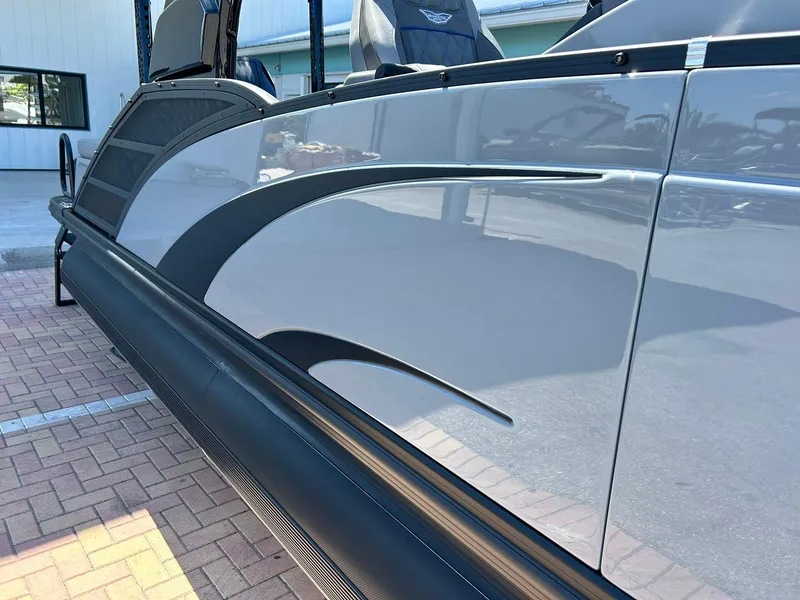 Slide: The Image of 2024 Bennington 28 QXSBA x1 pontoon boat with sleek black and gray design. - 9