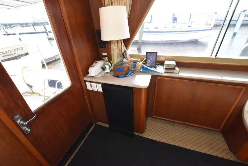 Slide: The Image of 1987 Hatteras SportFish yacht interior with wooden cabinetry and waterfront view. - 12