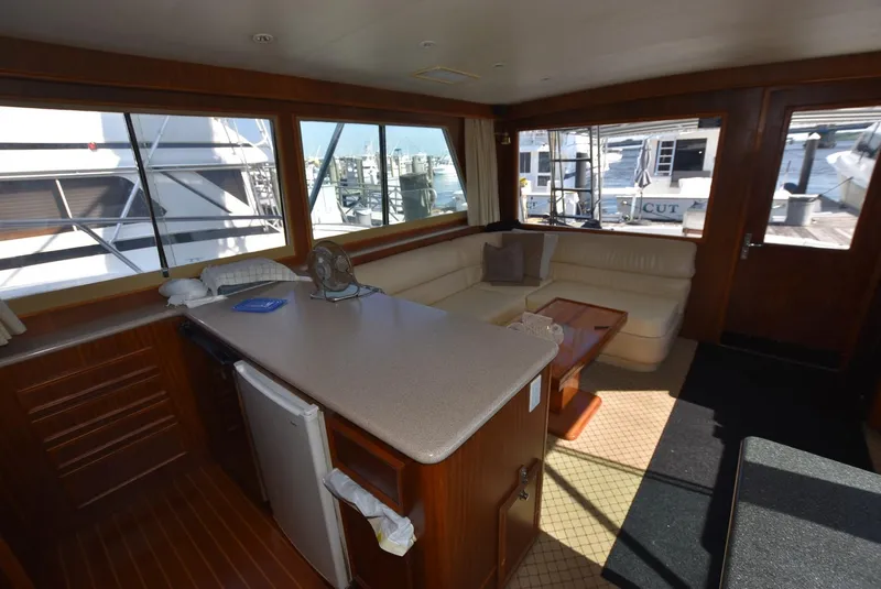 Slide: The Image of Interior of 1987 Hatteras SportFish yacht with CATS, featuring a cozy lounge area. - 18