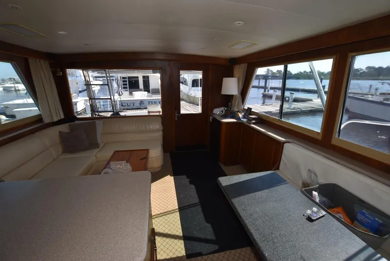 Slide: The Image of Interior of 1987 Hatteras SportFish yacht with dock view through large windows. - 19