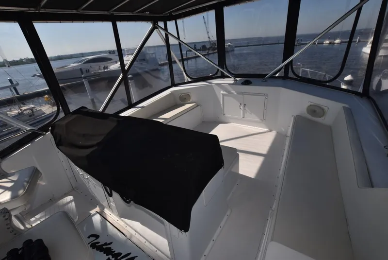 Slide: The Image of 1987 Hatteras SportFish (w/CATS) boat interior with panoramic windows and seating. - 3