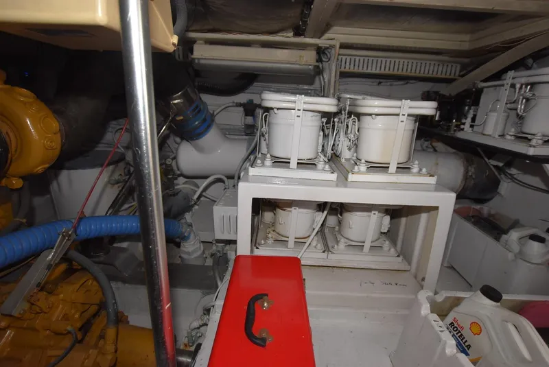 Slide: The Image of Engine room of a 1987 Hatteras SportFish (w/CATS) boat showing mechanical components. - 31
