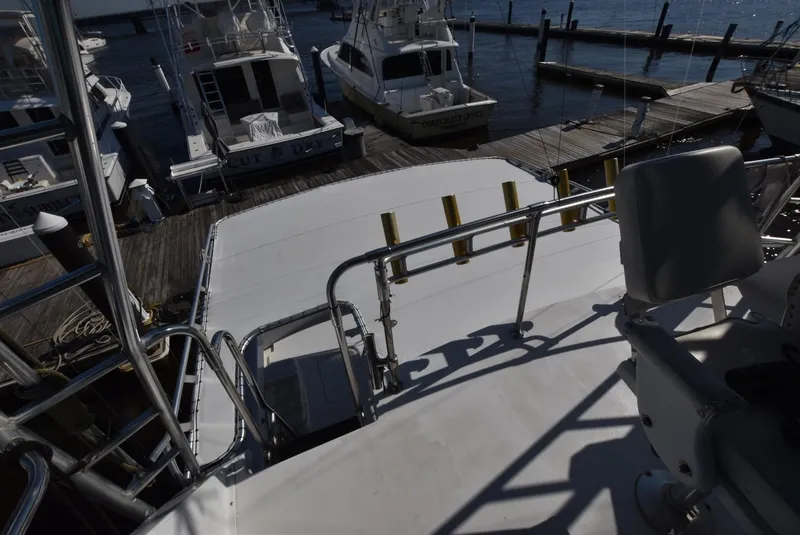 Slide: The Image of View from the deck of a 1987 Hatteras SportFish yacht docked at a marina. - 5