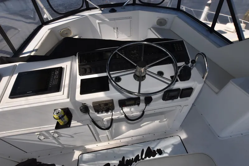Slide: The Image of 1987 Hatteras SportFish (w/CATS) boat helm with steering wheel and controls. - 6