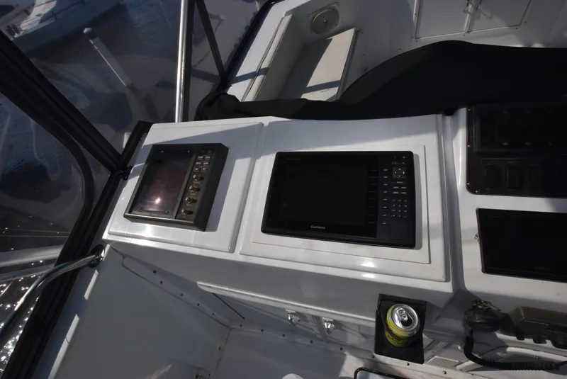 Slide: The Image of Control panel of a 1987 Hatteras SportFish (w/CATS) boat with navigation screens. - 7
