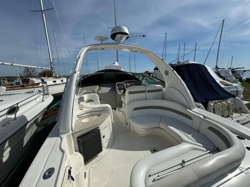Slide: The Image of 2006 Sea Ray 320 Sundancer boat interior with white seating and helm. - 10
