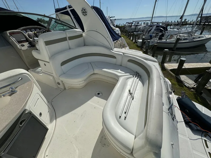 Slide: The Image of 2006 Sea Ray 320 Sundancer boat with spacious seating at a marina. - 11