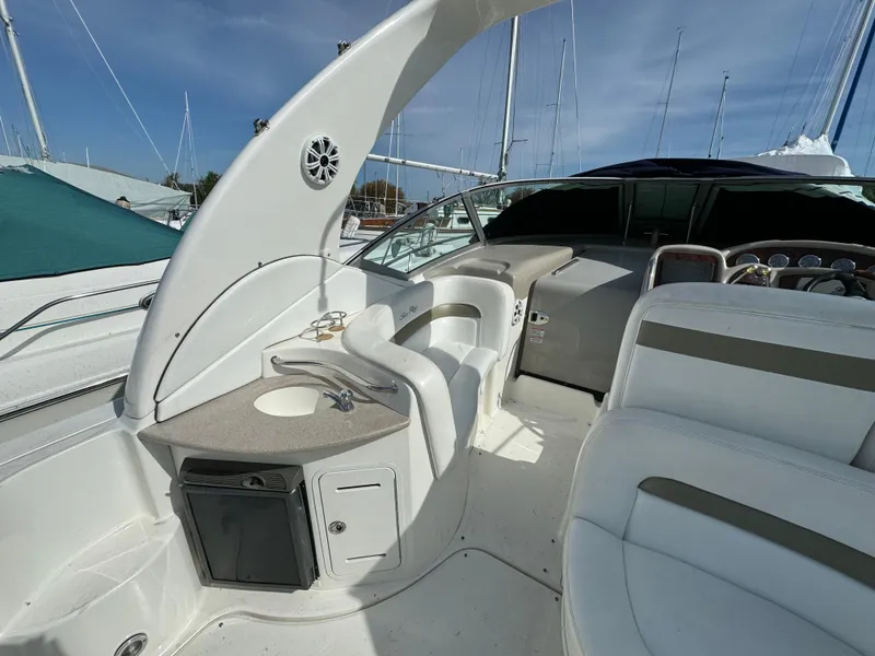 Slide: The Image of 2006 Sea Ray 320 Sundancer boat interior with seating and kitchenette. - 12