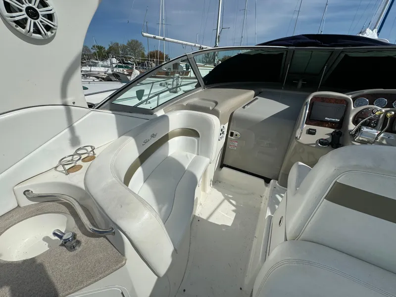 Slide: The Image of 2006 Sea Ray 320 Sundancer cockpit with seating and helm station. - 13