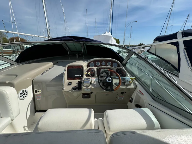 Slide: The Image of 2006 Sea Ray 320 Sundancer boat cockpit with steering wheel and control panel. - 15