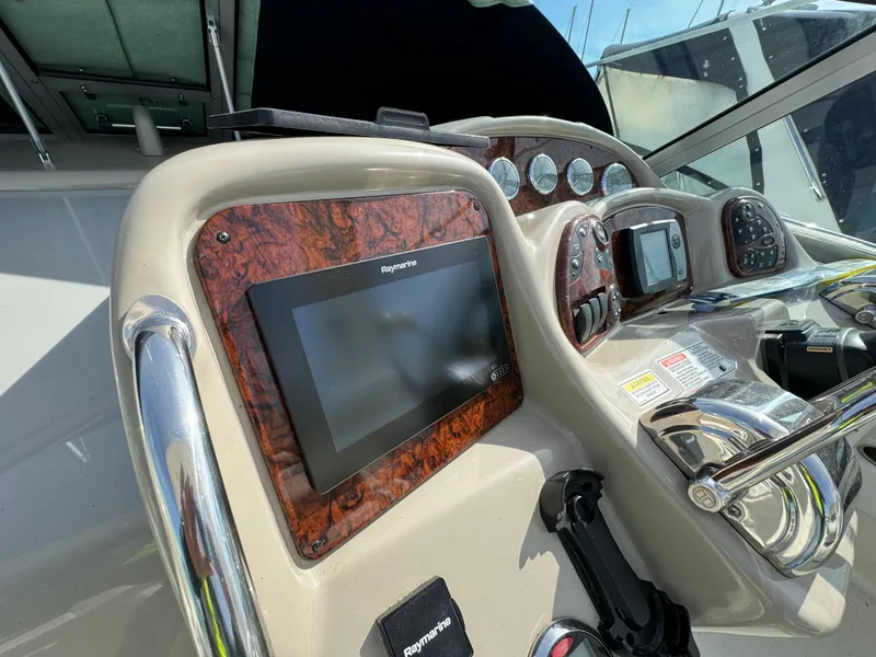 Slide: The Image of Control panel of a 2006 Sea Ray 320 Sundancer boat with navigation equipment. - 16