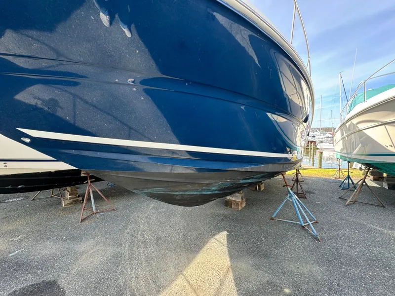 Slide: The Image of 2006 Sea Ray 320 Sundancer boat on stands for maintenance. - 2