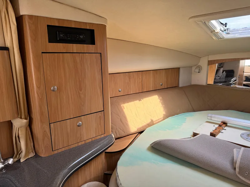 Slide: The Image of Interior cabin of a 2006 Sea Ray 320 Sundancer yacht with wood cabinetry. - 23