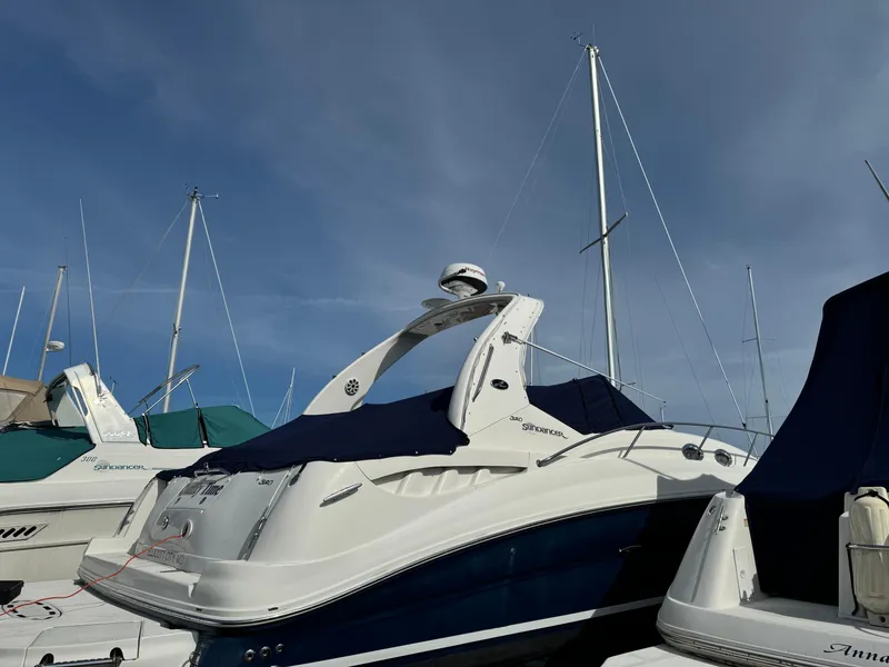 Slide: The Image of 2006 Sea Ray 320 Sundancer yacht docked at marina under clear sky. - 4