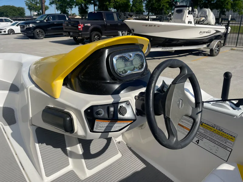 Slide: The Image of 2010 Sea-Doo 150 Speedster dashboard and steering wheel in a parking lot. - 10
