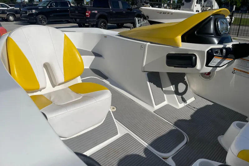 Slide: The Image of 2010 Sea-Doo 150 Speedster interior with yellow and white seating. - 13