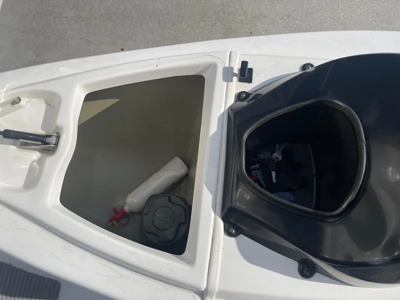 Slide: The Image of Open storage compartments on a 2010 Sea-Doo 150 Speedster boat. - 16