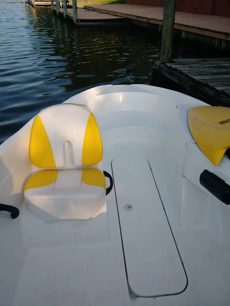 Slide: The Image of 2010 Sea-Doo 150 Speedster boat interior with yellow and white seating. - 22