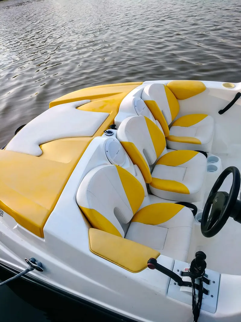 Slide: The Image of 2010 Sea-Doo 150 Speedster with yellow and white seats on the water. - 23
