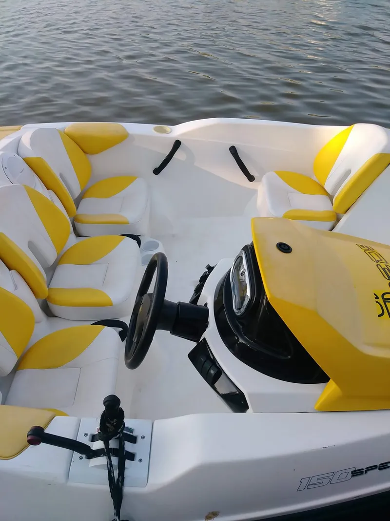 Slide: The Image of 2010 Sea-Doo 150 Speedster boat interior with yellow and white seats on water. - 24