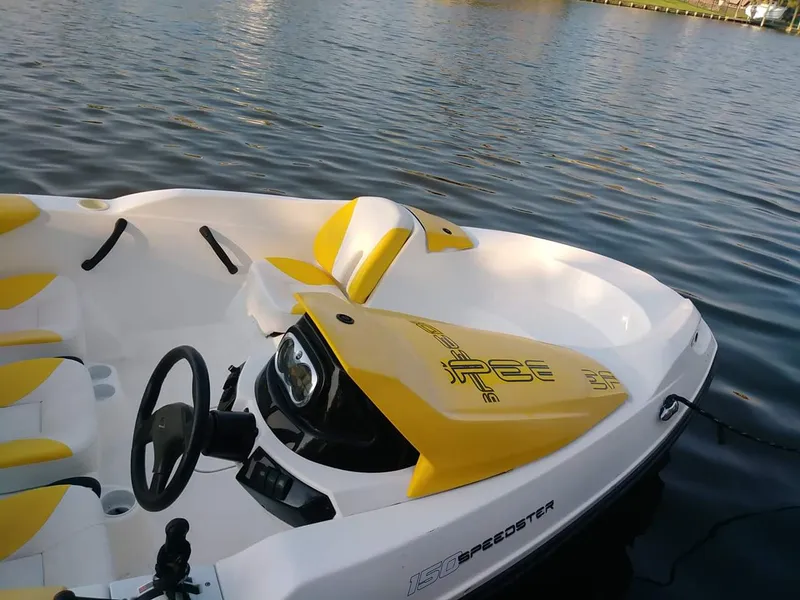 Slide: The Image of 2010 Sea-Doo 150 Speedster boat with yellow and white interior on calm water. - 25