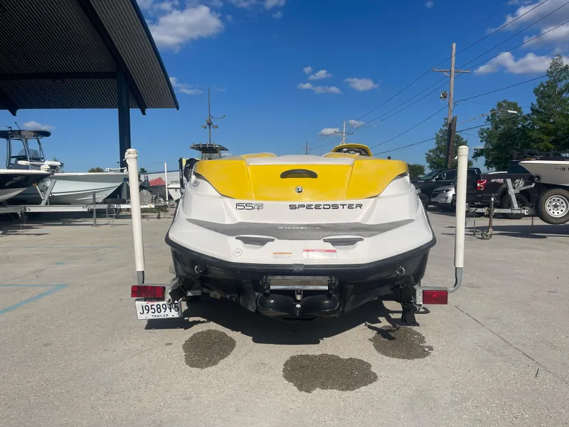 Slide: The Image of 2010 Sea-Doo 150 Speedster boat rear view in a marina. - 3