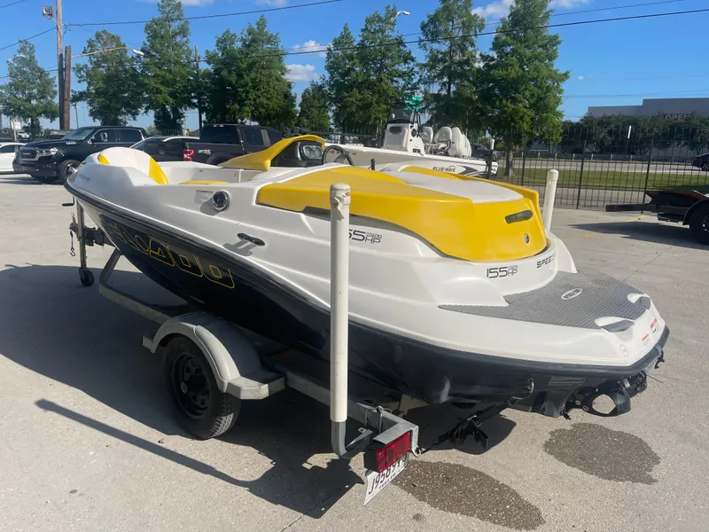 Slide: The Image of 2010 Sea-Doo 150 Speedster boat on a trailer in a parking lot. - 4