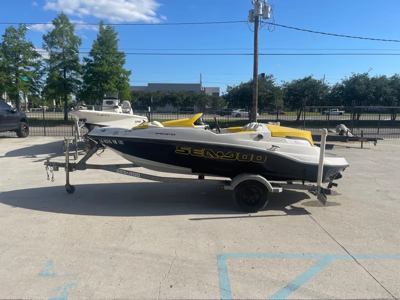 Slide: The Image of 2010 Sea-Doo 150 Speedster on a trailer in a parking lot. - 5