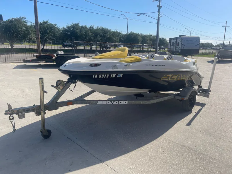 Slide: The Image of 2010 Sea-Doo 150 Speedster on a trailer in a parking lot. - 6