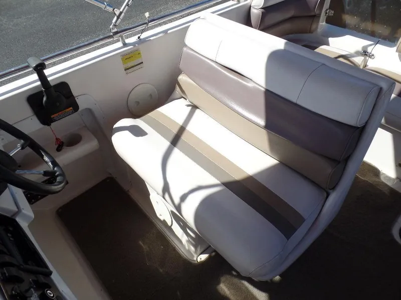 Slide: The Image of 1996 Hurricane Fun Deck boat interior with cushioned seating and steering controls. - 10
