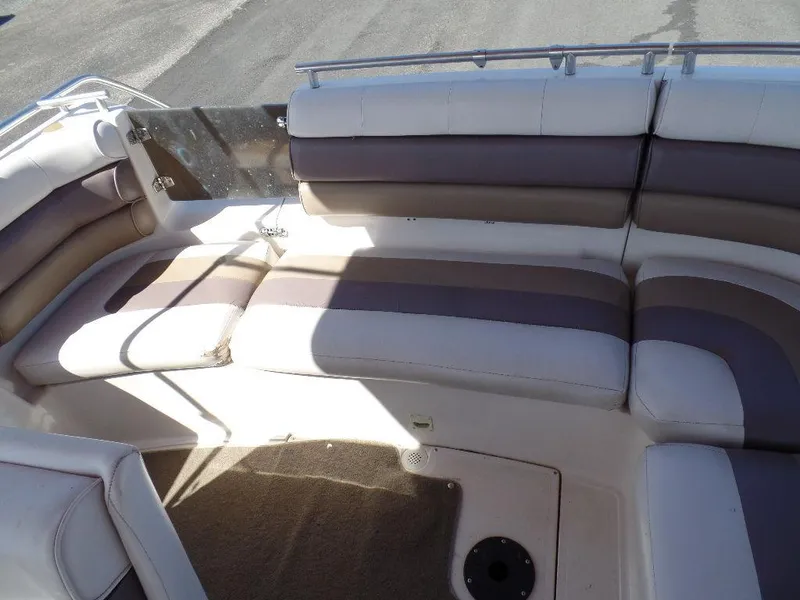 Slide: The Image of 1996 Hurricane Fun Deck boat interior with cushioned seating and carpeted floor. - 11
