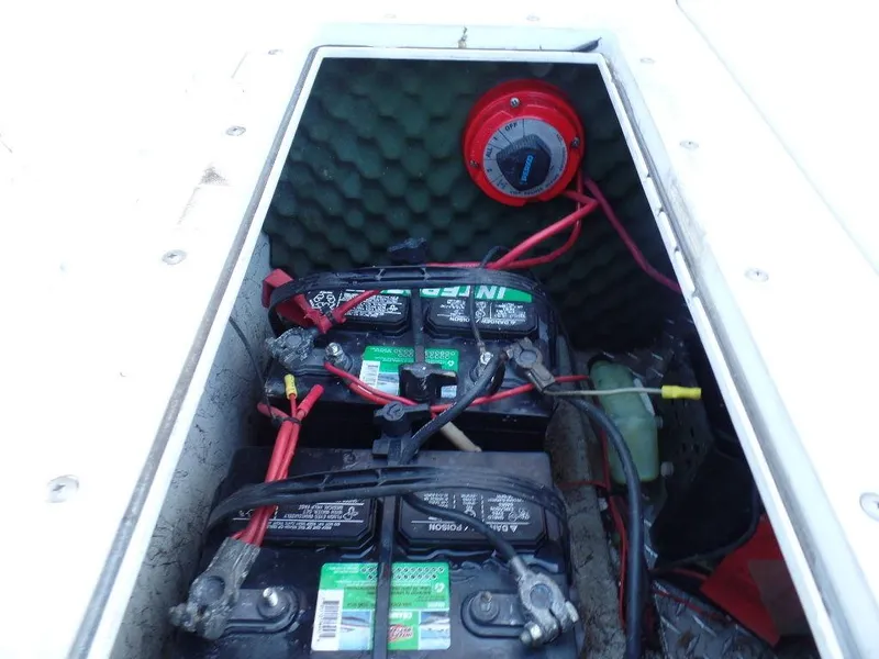 Slide: The Image of Battery compartment of a 1996 Hurricane Fun Deck boat with dual batteries and switch. - 15