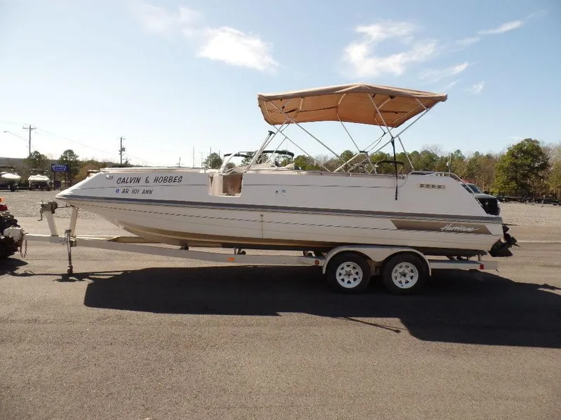 Slide: The Image of 1996 Hurricane Fun Deck boat on trailer with canopy in parking lot. - 16
