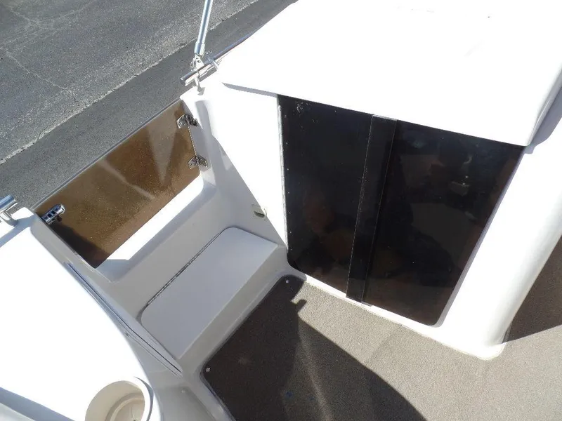 Slide: The Image of 1996 Hurricane Fun Deck boat interior with storage compartment and seating area. - 2