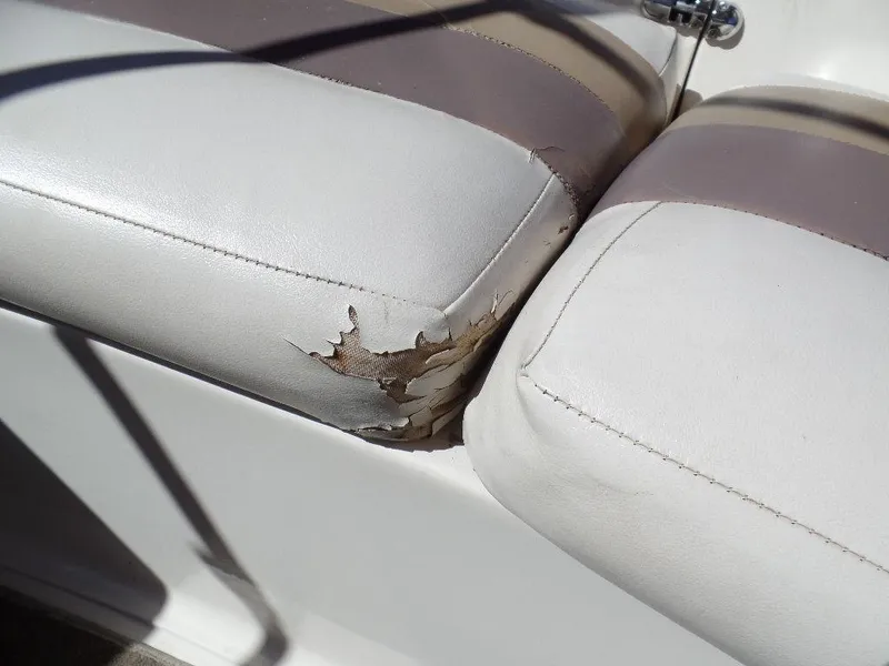Slide: The Image of 1996 Hurricane Fun Deck boat seat with torn upholstery. - 7