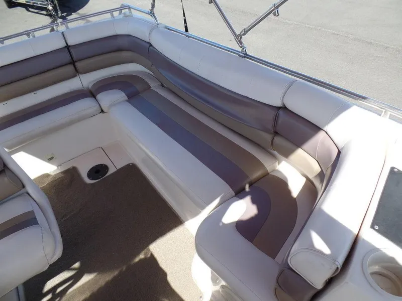 Slide: The Image of 1996 Hurricane Fun Deck boat interior with cushioned seating and carpeted floor. - 9