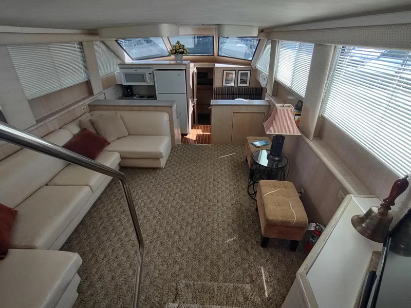 Slide: The Image of Interior of 1995 Hatteras 52 Cockpit Motor Yacht with spacious seating and modern amenities. - 15