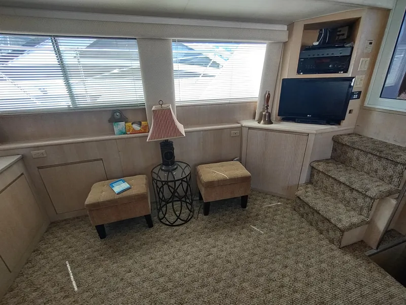 Slide: The Image of Interior of 1995 Hatteras 52 Cockpit Motor Yacht with seating, TV, and lamp. - 17