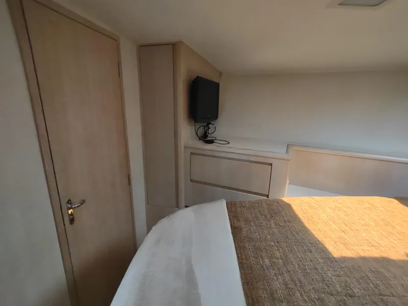 Slide: The Image of Interior of 1995 Hatteras 52 Cockpit Motor Yacht with TV and wooden cabinetry. - 23