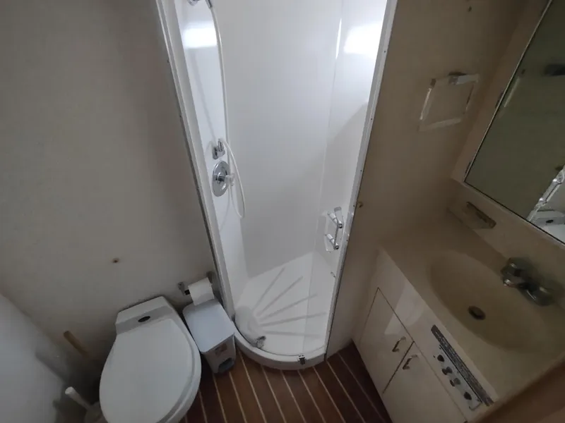 Slide: The Image of Bathroom in 1995 Hatteras 52 Cockpit Motor Yacht with shower, toilet, and sink. - 25