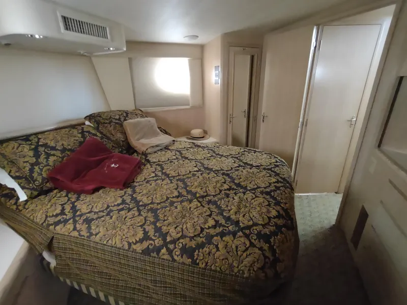 Slide: The Image of Luxurious bedroom interior of 1995 Hatteras 52 Cockpit Motor Yacht with elegant bedding. - 29