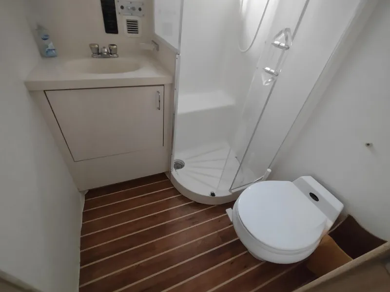 Slide: The Image of Bathroom interior of 1995 Hatteras 52 Cockpit Motor Yacht with shower, sink, and toilet. - 34