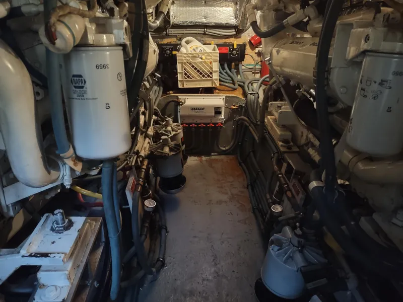 Slide: The Image of Engine room of a 1995 Hatteras 52 Cockpit Motor Yacht, showcasing machinery and equipment. - 37