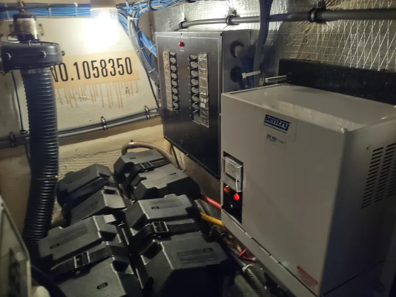 Slide: The Image of Engine room of 1995 Hatteras 52 Cockpit Motor Yacht with electrical panel and equipment. - 43