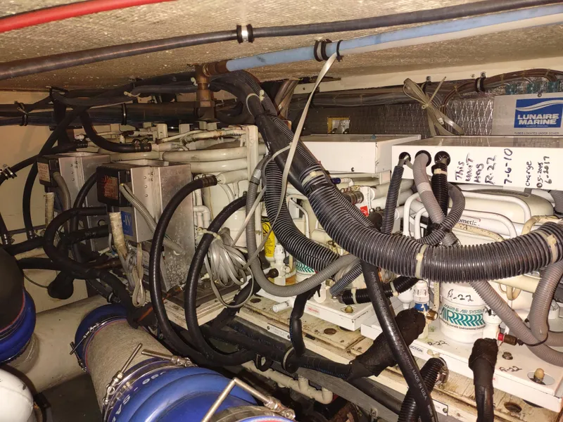 Slide: The Image of Engine room of 1995 Hatteras 52 Cockpit Motor Yacht with complex wiring and machinery. - 45