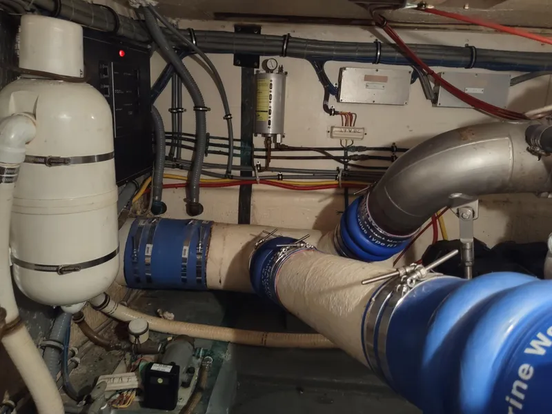 Slide: The Image of Engine room of 1995 Hatteras 52 Cockpit Motor Yacht with pipes and wiring. - 46