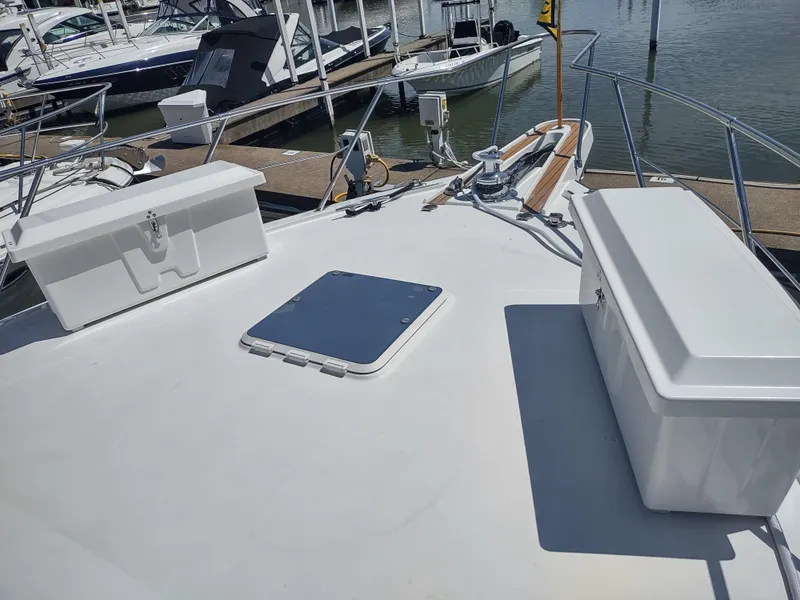 Slide: The Image of 1995 Hatteras 52 Cockpit Motor Yacht deck with storage boxes and hatch. - 5
