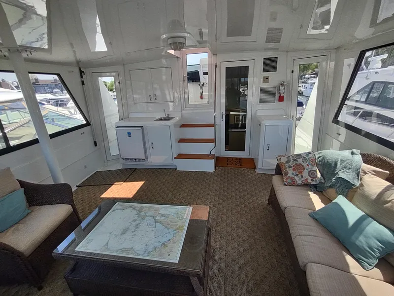 Slide: The Image of Interior of 1995 Hatteras 52 Cockpit Motor Yacht with cozy seating and nautical decor. - 6