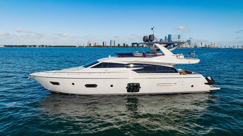 Slide: The Image of 2017 Ferretti Yachts 750 cruising on open water with city skyline in background. - 1